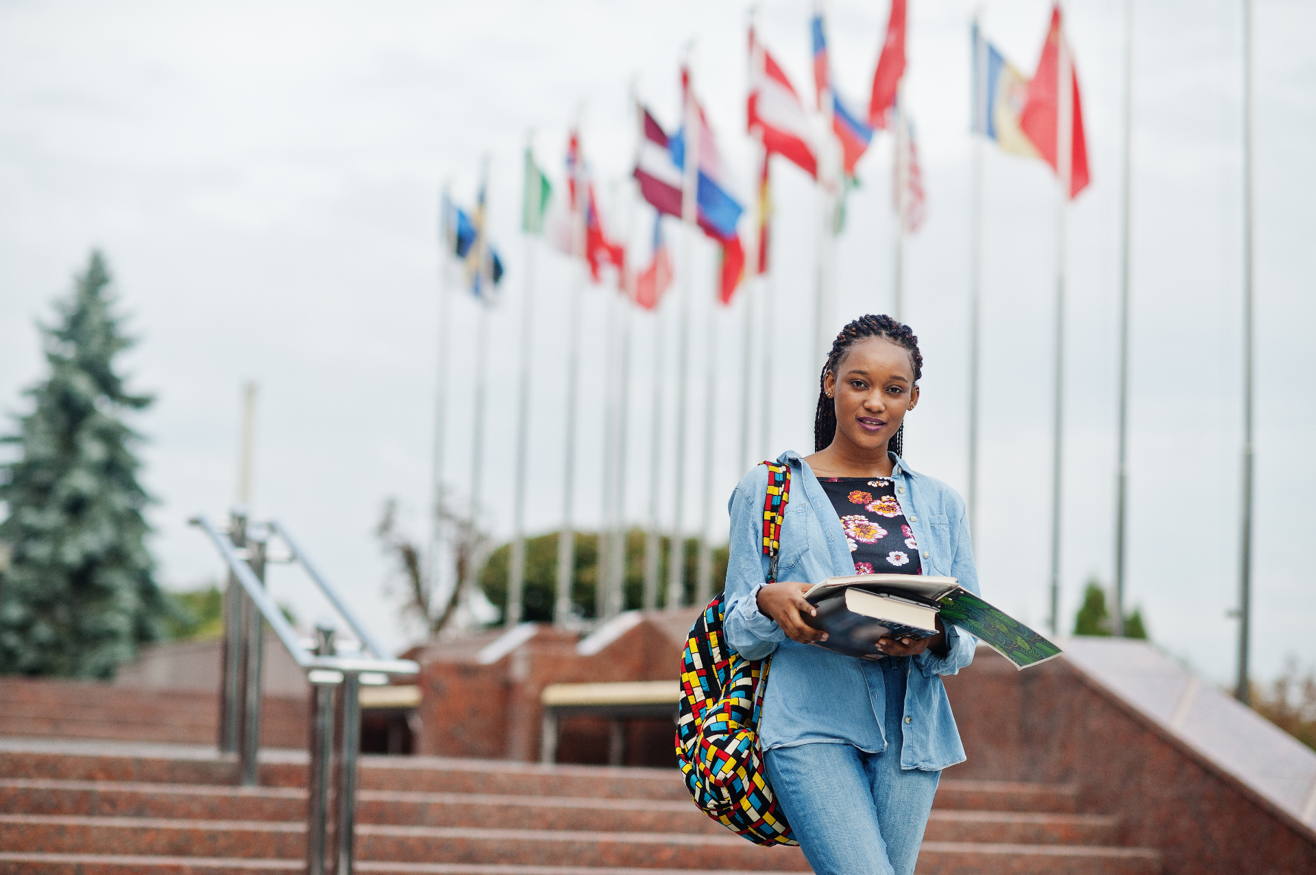 International student standing in front of country flags